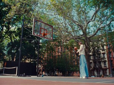 a couple of people standing on a basketball court