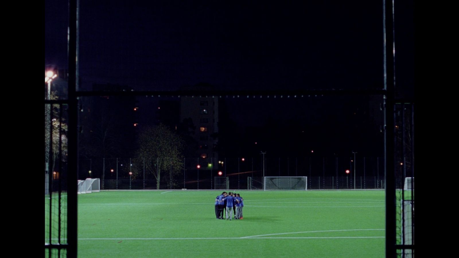 a group of people standing on top of a soccer field