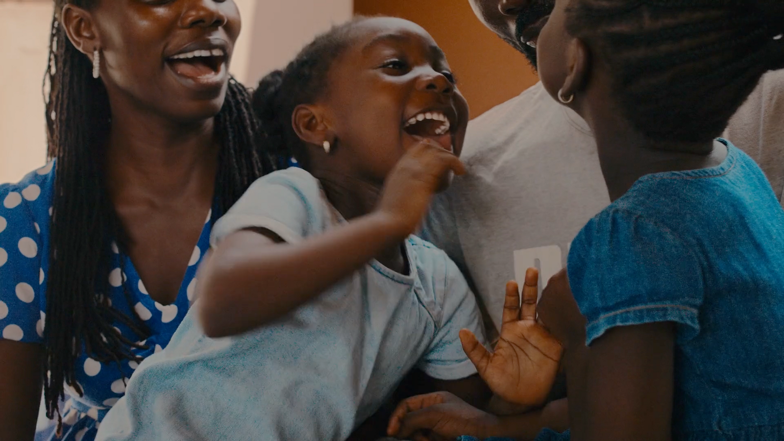 a woman and two children laughing together