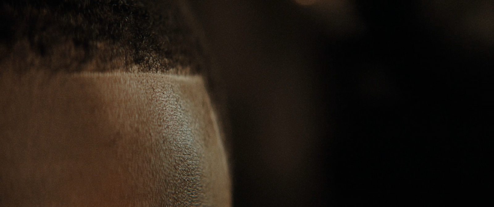 a close up of a person's hair with a blurry background