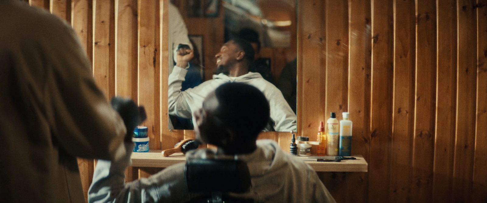 a man sitting in a chair in front of a mirror