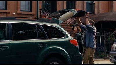 a group of people standing next to a car