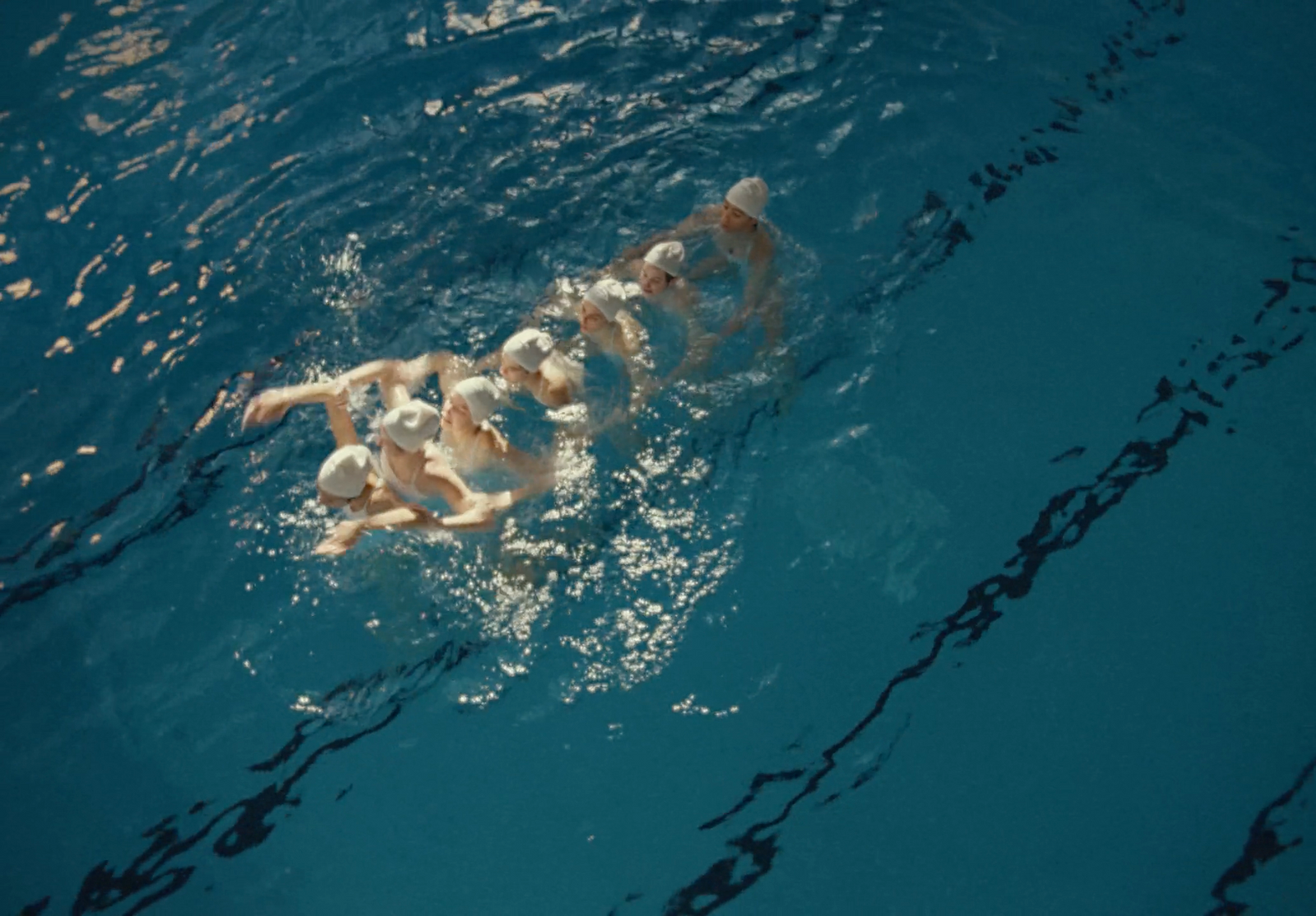 a group of people swimming in a pool