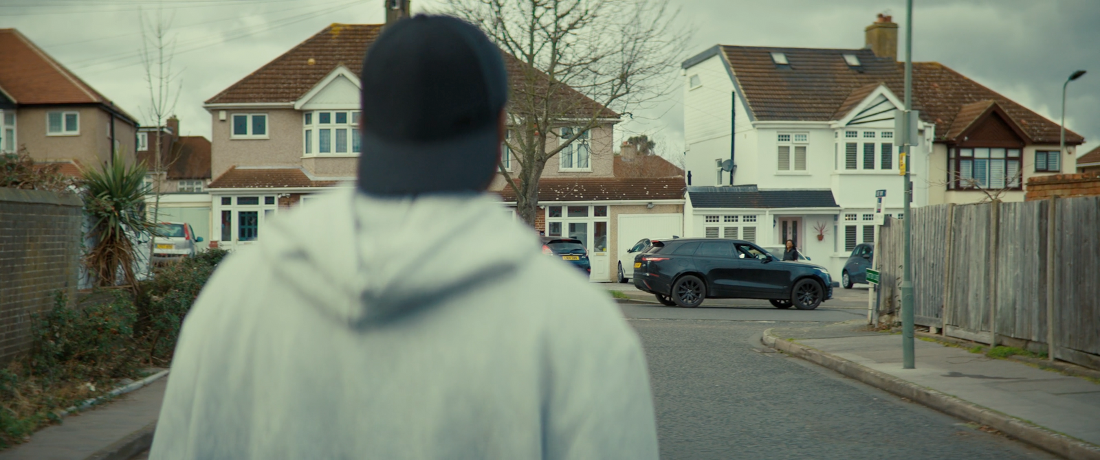 a nun walking down a street in front of a row of houses