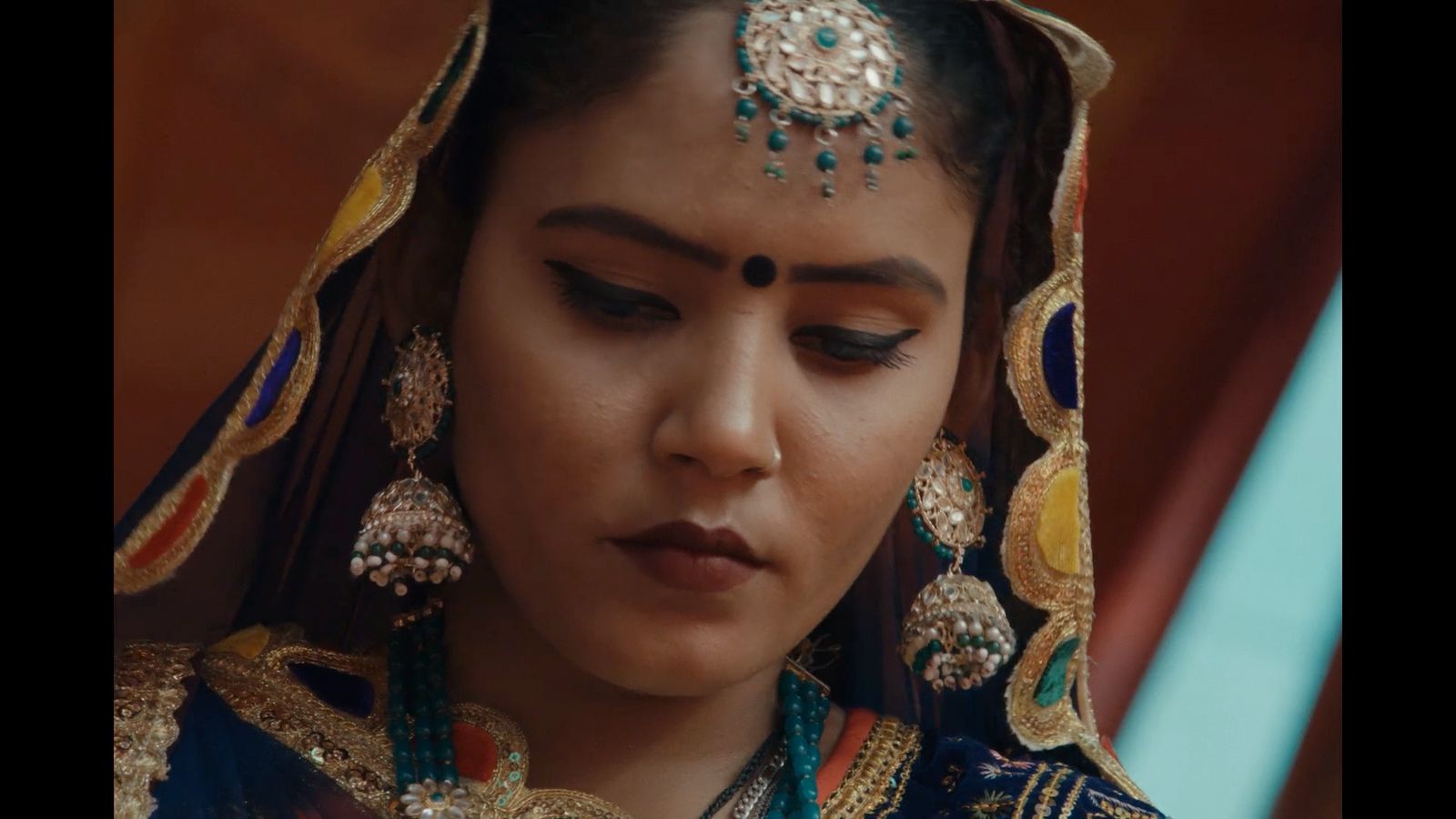 a woman wearing a head piece and jewelry