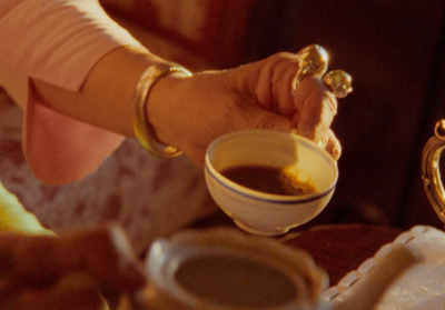 a woman is pouring a cup of coffee