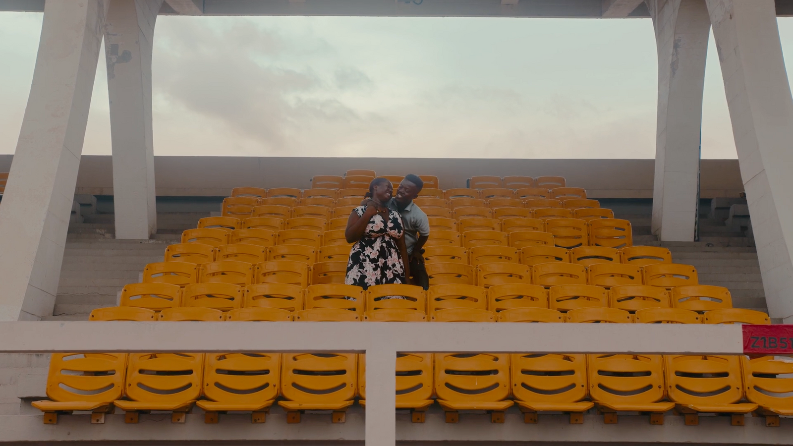 a man and a woman sitting in a stadium