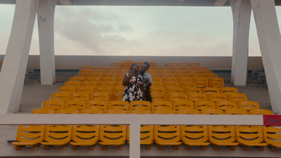 a man and a woman sitting in a stadium