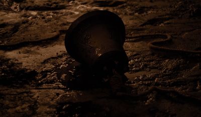 a bottle that is sitting in the dirt