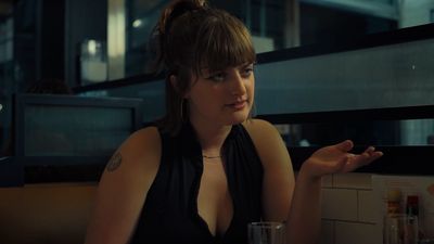 a woman sitting at a table in a restaurant