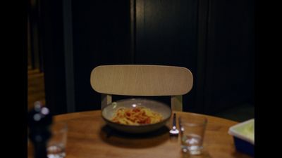 a bowl of food sitting on top of a wooden table