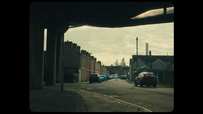 a city street with cars parked on the side of it