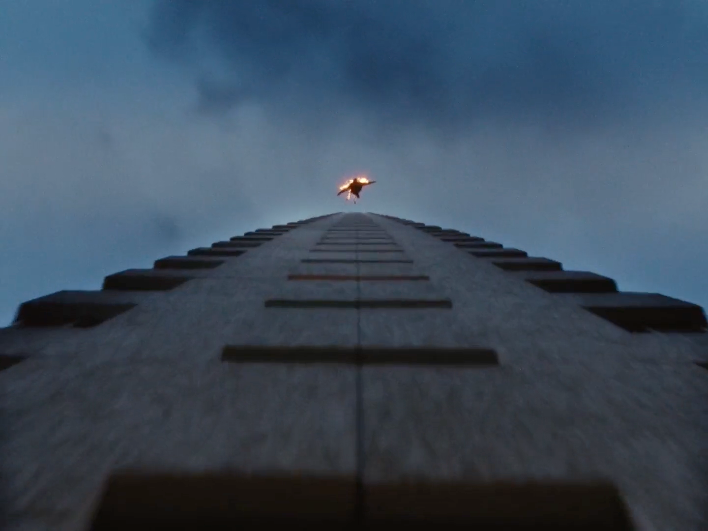 a tall building with a sky in the background