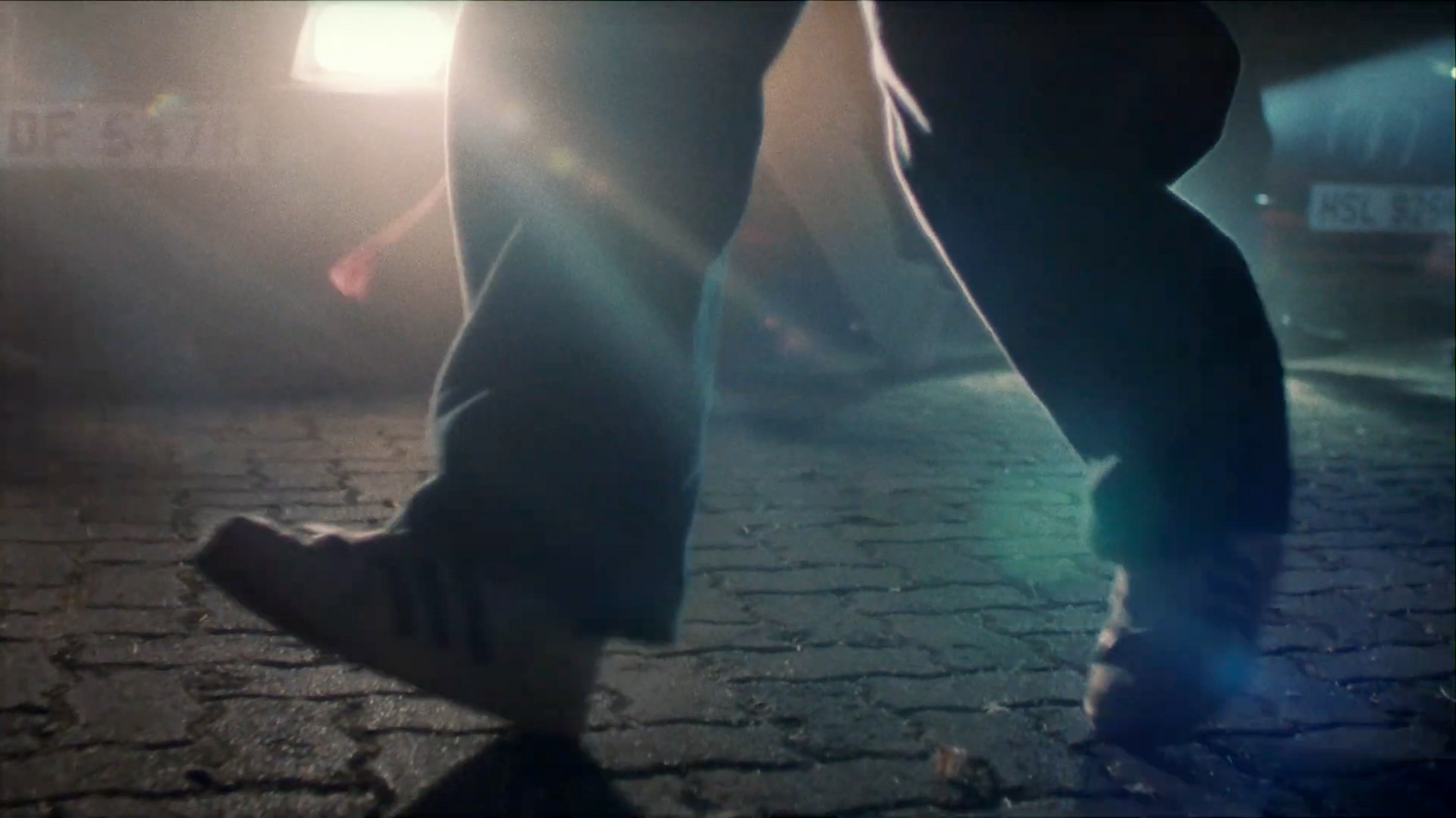 a person standing on a street with their foot on a skateboard