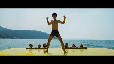 a man standing on top of a yellow raft in the ocean