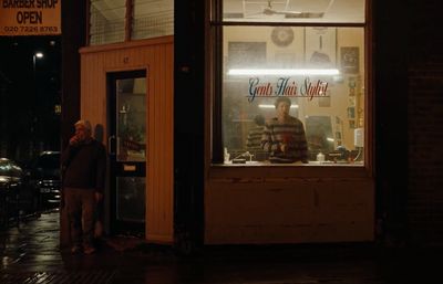 a couple of people standing outside of a store