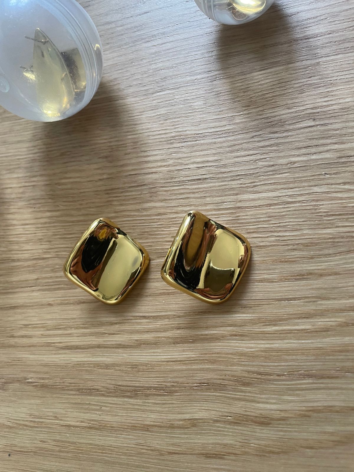 a close up of a pair of earrings on a table