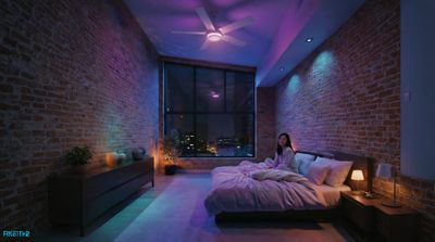 a woman sitting on a bed in a room with brick walls