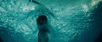 a person swimming in a pool of water