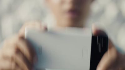 a woman holding a nintendo wii game controller