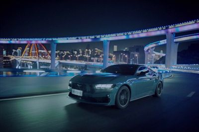 a car driving down a city street at night