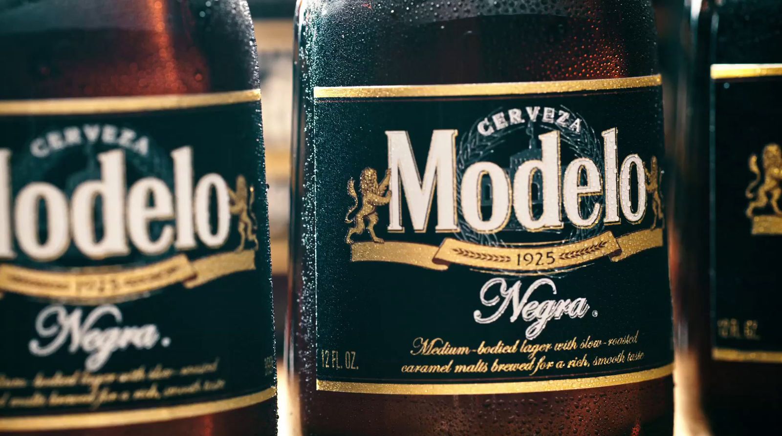 three bottles of modelo beer sitting next to each other