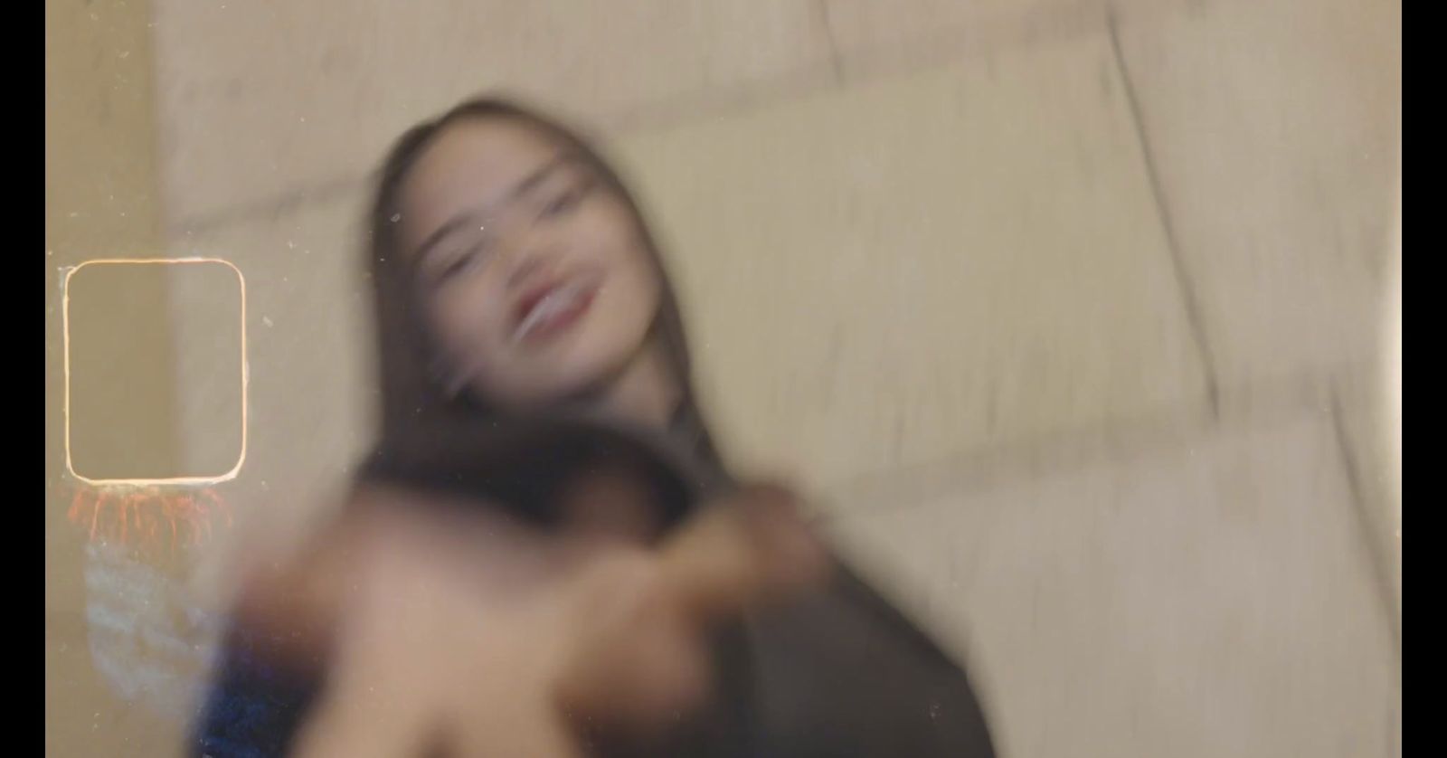 a blurry photo of a woman with her eyes closed