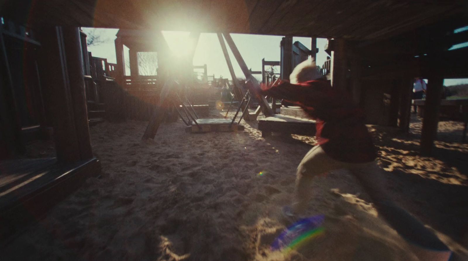 a child is playing in the sand at a playground