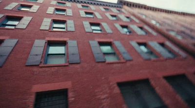 a tall red brick building with lots of windows