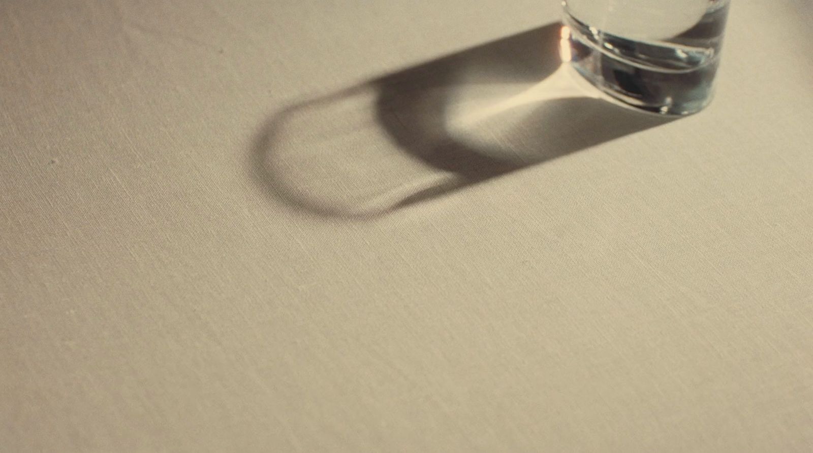 a glass of water sitting on top of a table