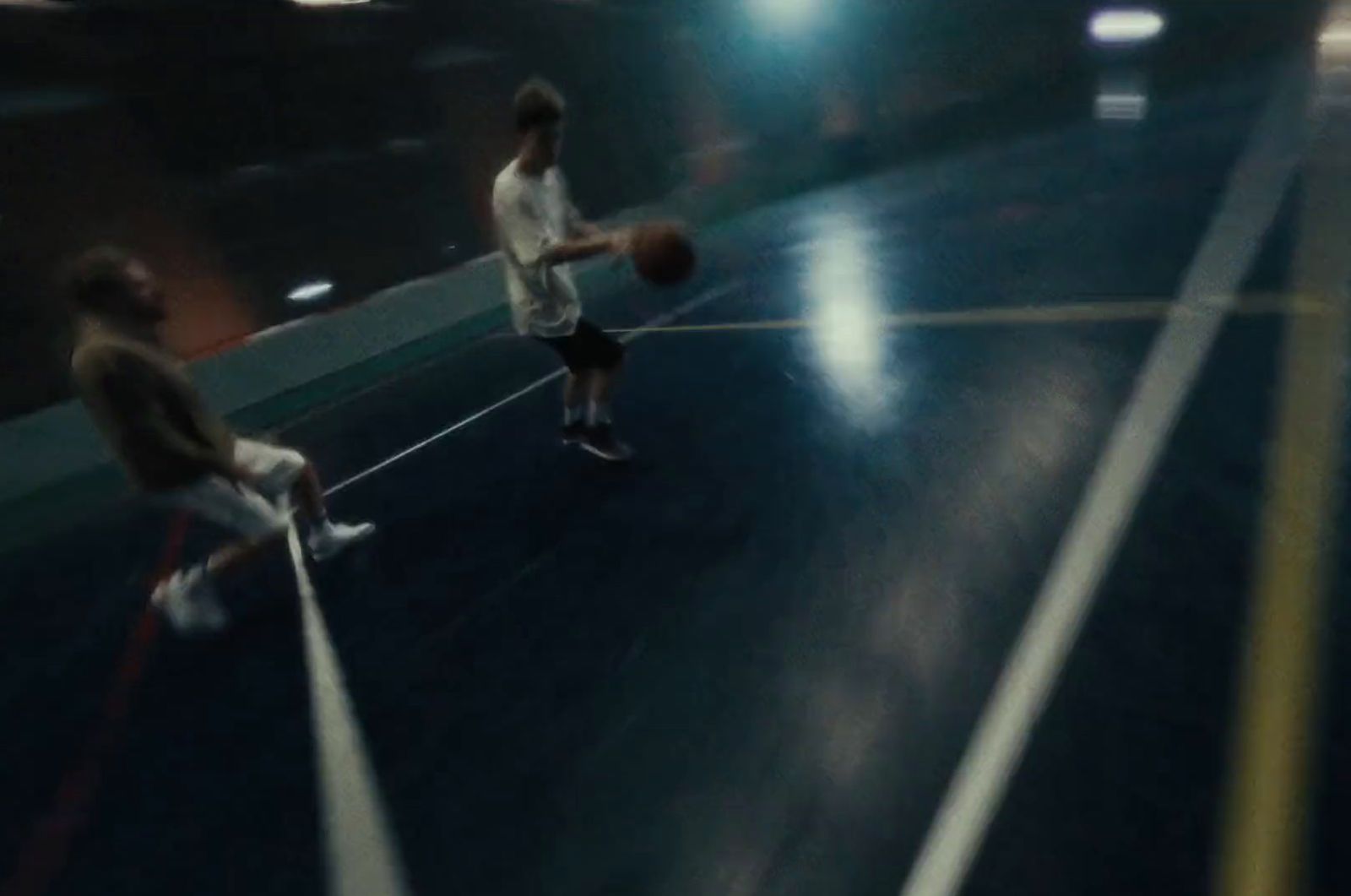 two men are playing basketball on a court