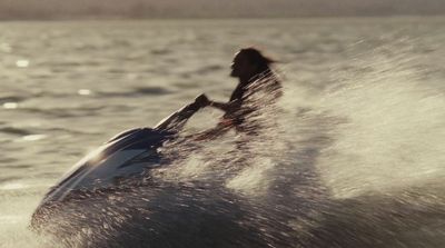 a person riding a surfboard on a body of water