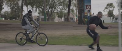 a couple of men riding bikes down a street