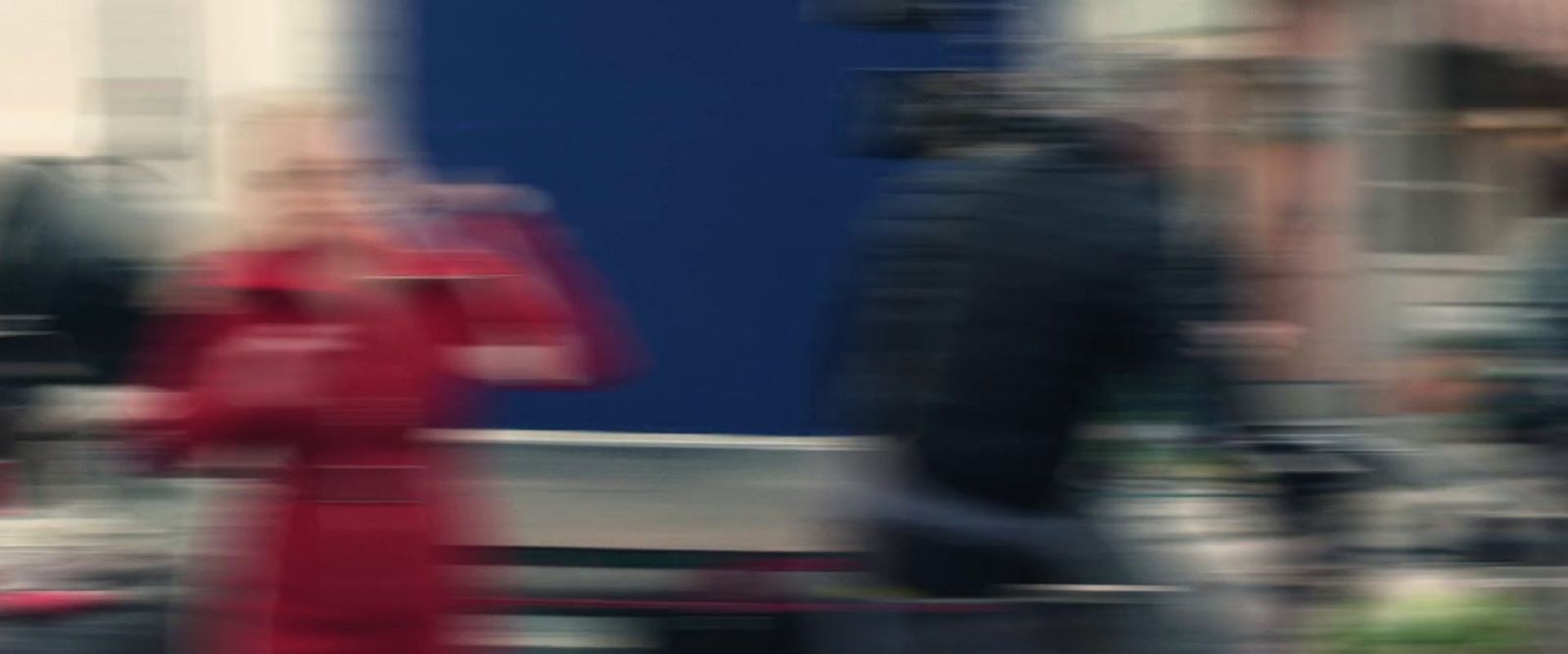 a blurry photo of a person walking down a street