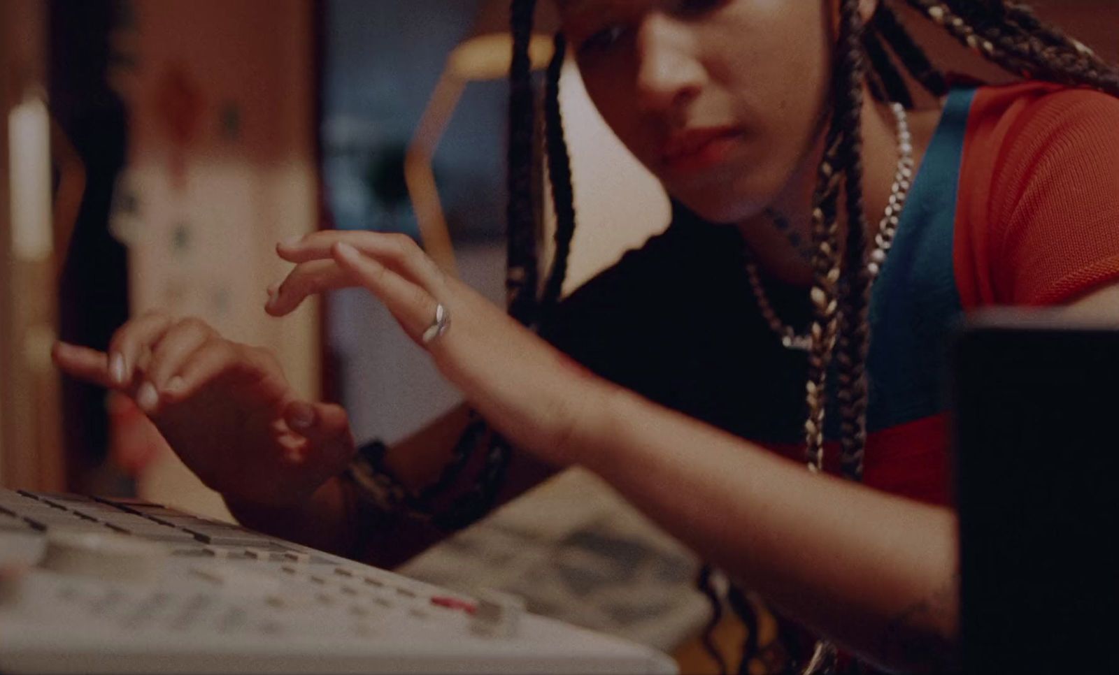 a woman with dreadlocks using a laptop computer