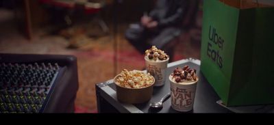 a couple of cups of popcorn sitting on top of a table