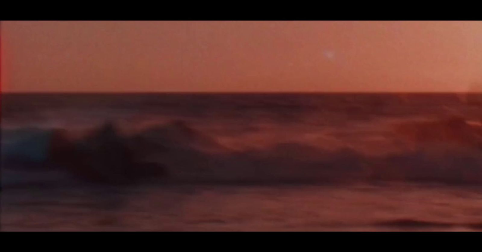 a person riding a surfboard on a wave in the ocean