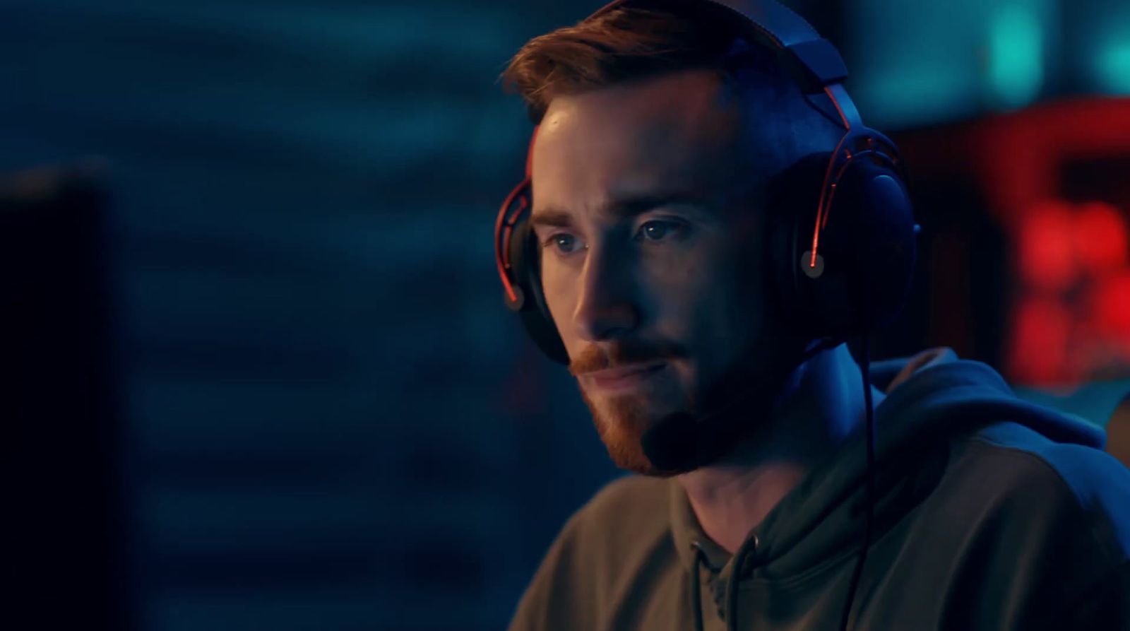 a man wearing headphones in a dark room