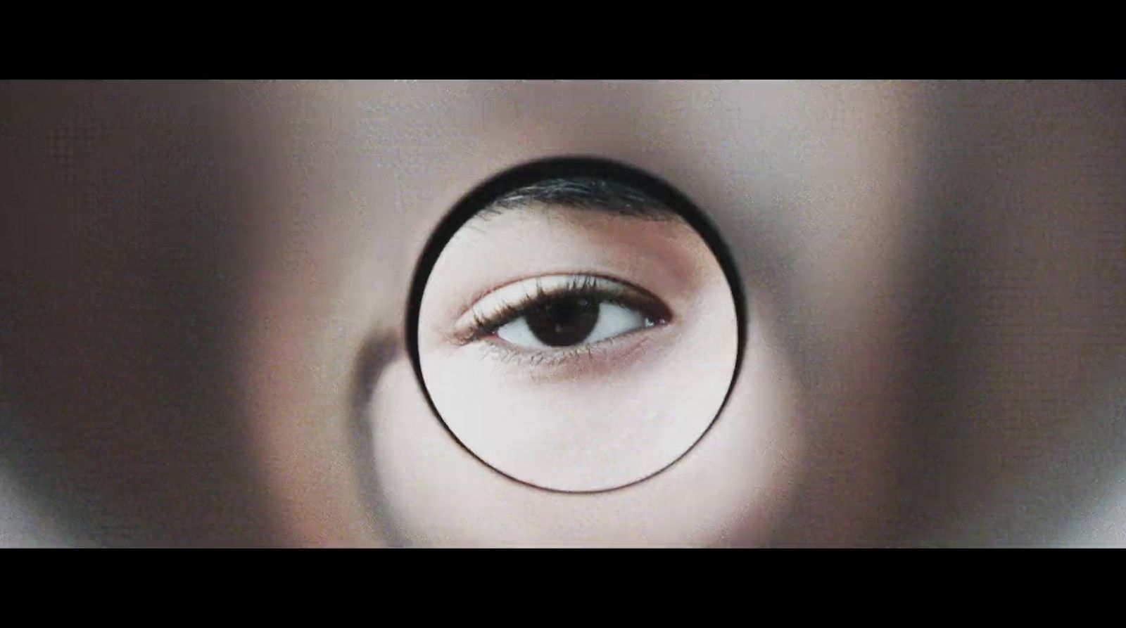 a woman's eye looking through a magnifying glass