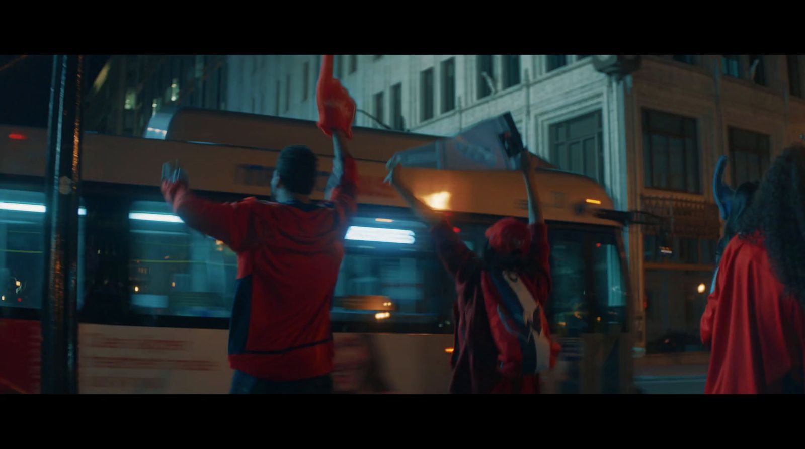 a group of people standing next to a bus