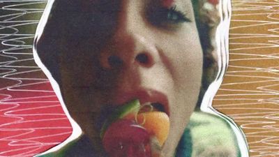 a woman eating a piece of fruit in her mouth