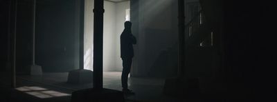 a person standing in a dark room in the dark