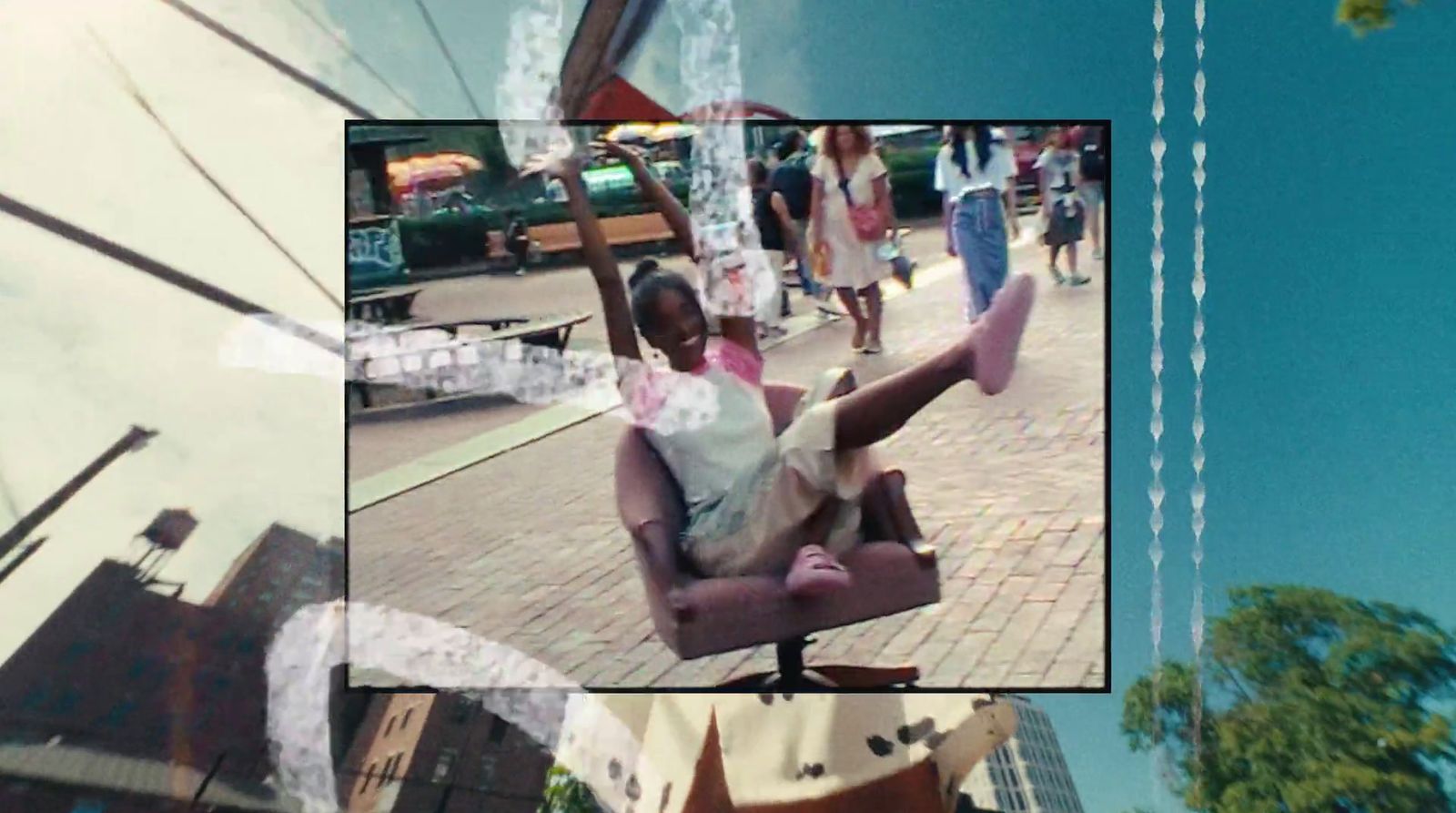 a man sitting in a chair on a city street