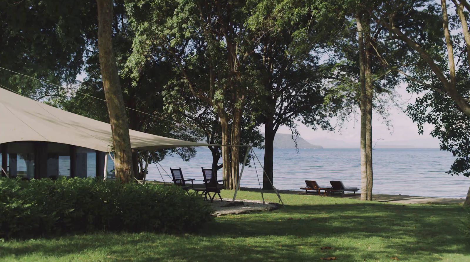 a tent set up on the shore of a lake