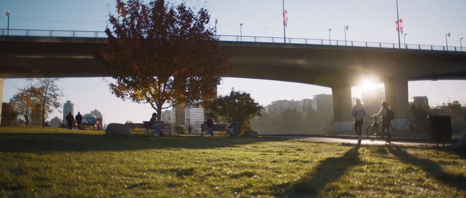 a person riding a bike under a bridge