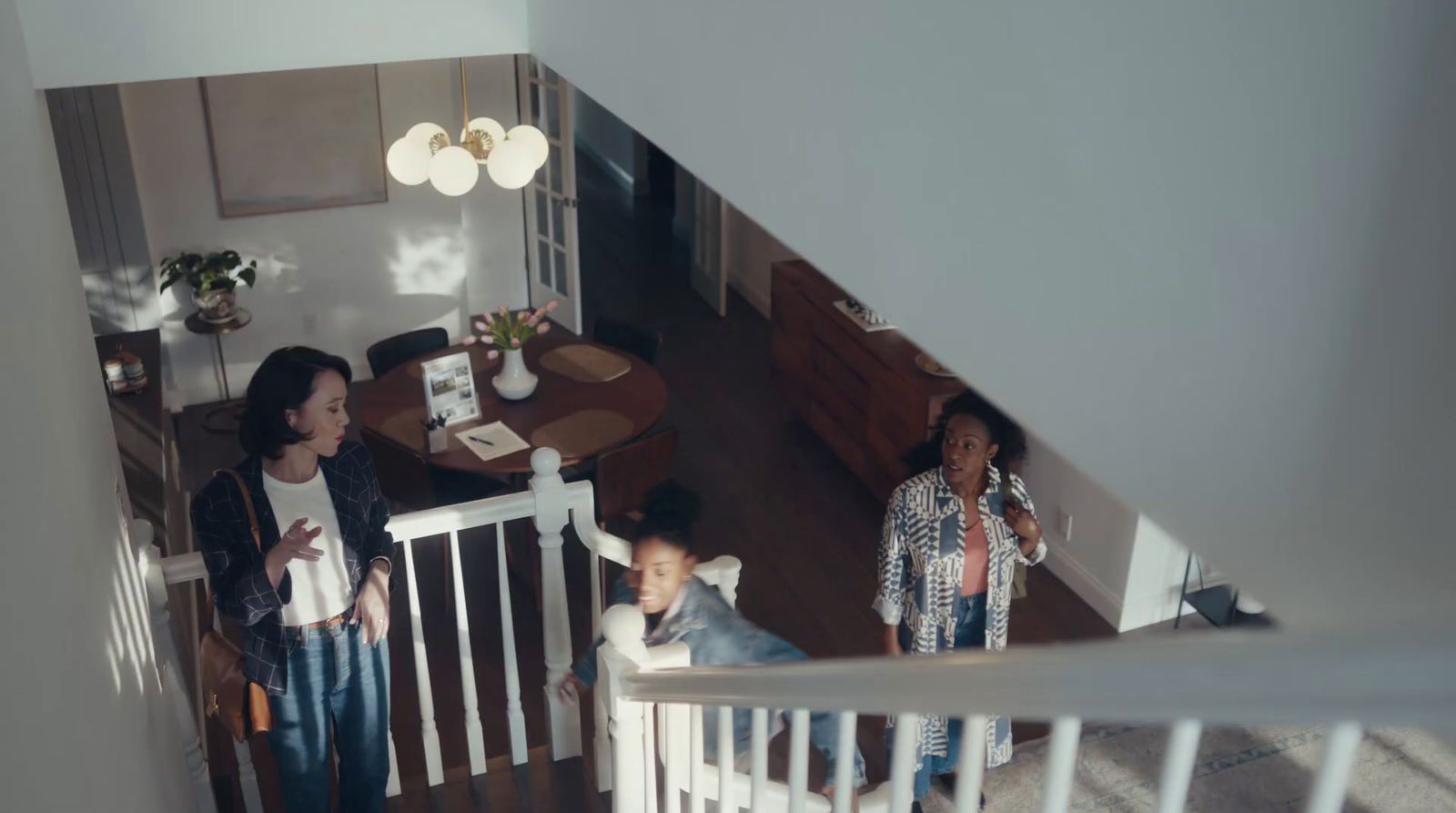 a couple of women standing on top of a stair case