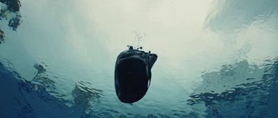 a boat floating in the water with a sky background