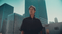 a man standing in front of a tall building