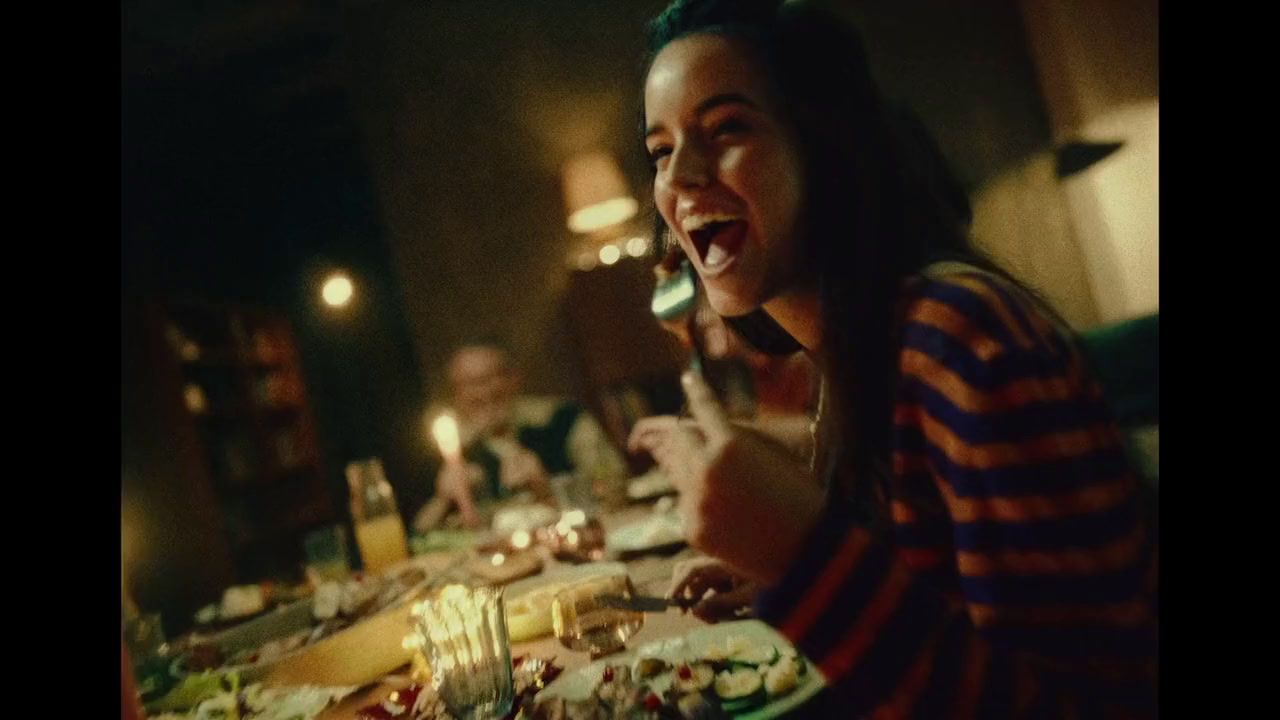 a woman sitting at a table with a plate of food