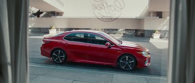 a red car parked in front of a building